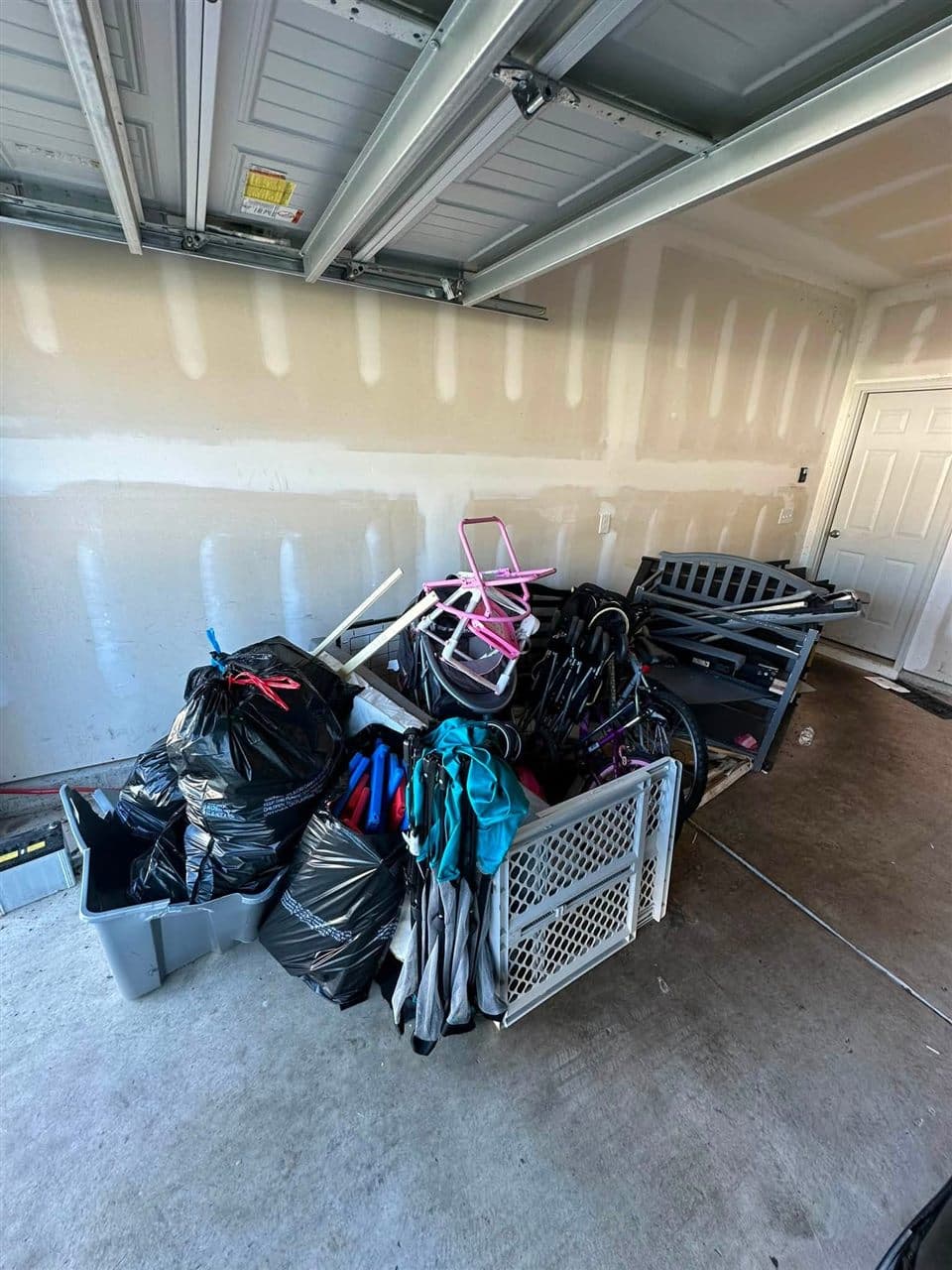 Garage packed with bags, old furniture and junk before the N&T cleanout